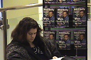 A customer reads her copy of 